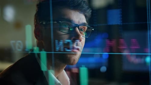 Focused Man Analyzing Financial Data in Modern Workplace