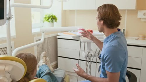 Dentist Explains Procedure to Patient in Office