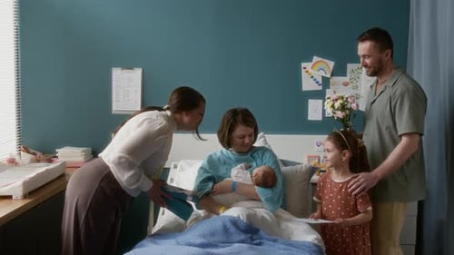 Family Visiting Young Mother in Maternity Hospital