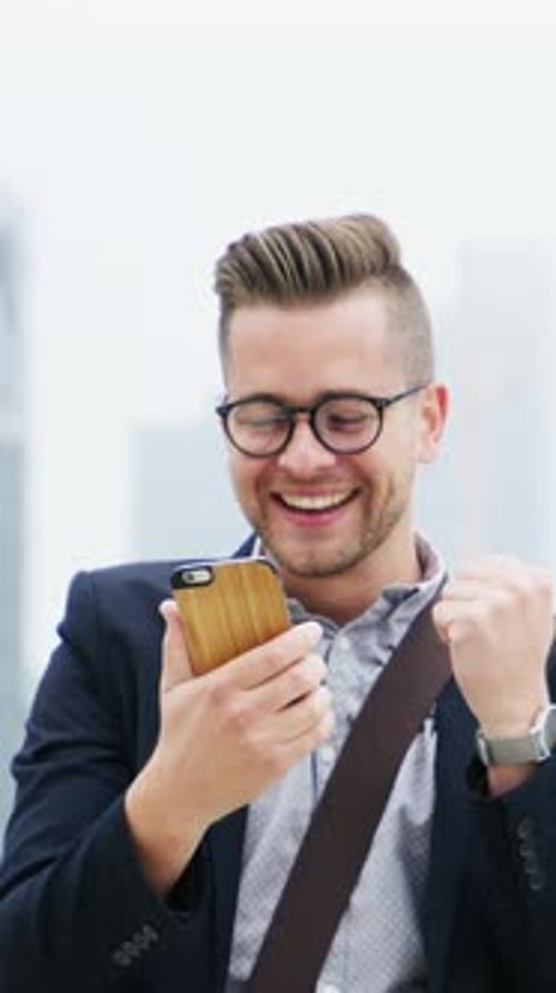 Fist pump, winning and businessman with phone in city for good news, stock market success and bonus