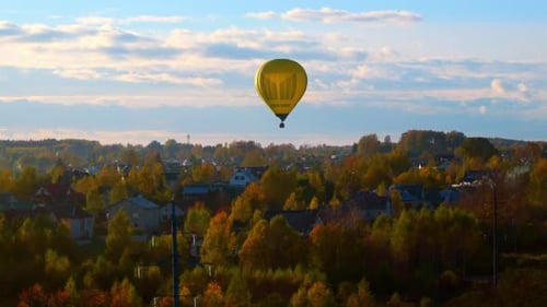 Vibrant Autumn Color Trees On Vilnius Old Town With Flying Hot Air Balloon In Lithuania. Aerial Shot