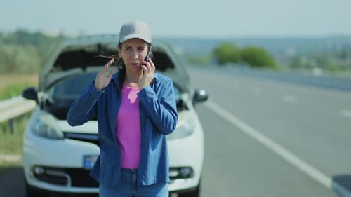 Frustrated Woman Contacts Car Assistance Service From the Freeway