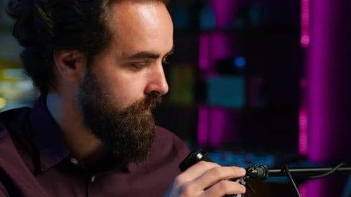 Portrait of Man Using Professional Microphone to Record Podcast Close Up