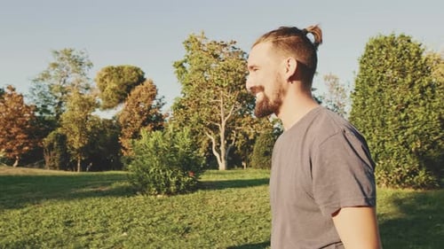 Couple Embracing and Kissing in a City Park