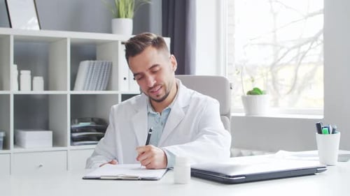 Doctor Works in the Medical Office Workplace of a Professional Therapist in a Hospital or Clinic