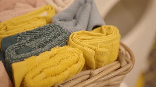 Rolled Pastel Towels in Basket Close Up