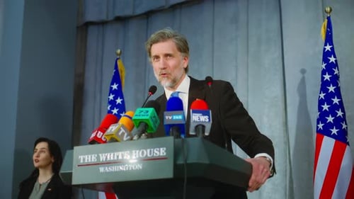 Mature Man Speaking at a Press Conference