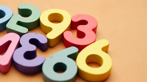 Bright Wooden Numbers on an Orange Background