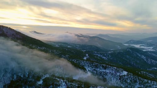 Golden Clouds Over Misty Mountain Peaks 4K