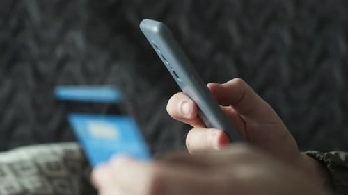 Smartphone Finance: Holding Credit Card, Using Mobile App