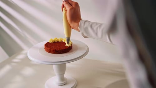Decorating a Cake with Yellow Cream Frosting