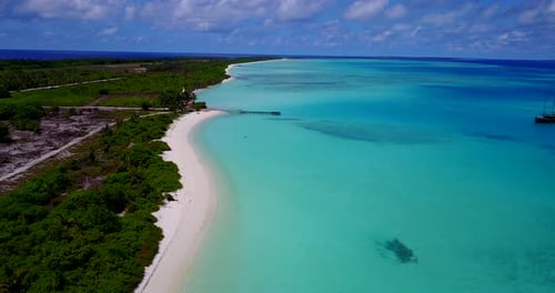Split scene with tropical ocean and green lush forrest. Aerial rise of Maldives beach on sunny day r
