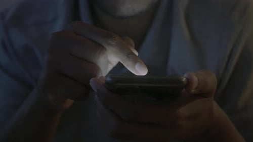 Close Up of Man's Hand Using Smart Phone at Night