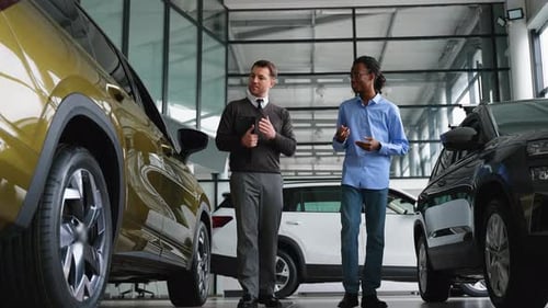 Men Talking About Cars in a Dealership