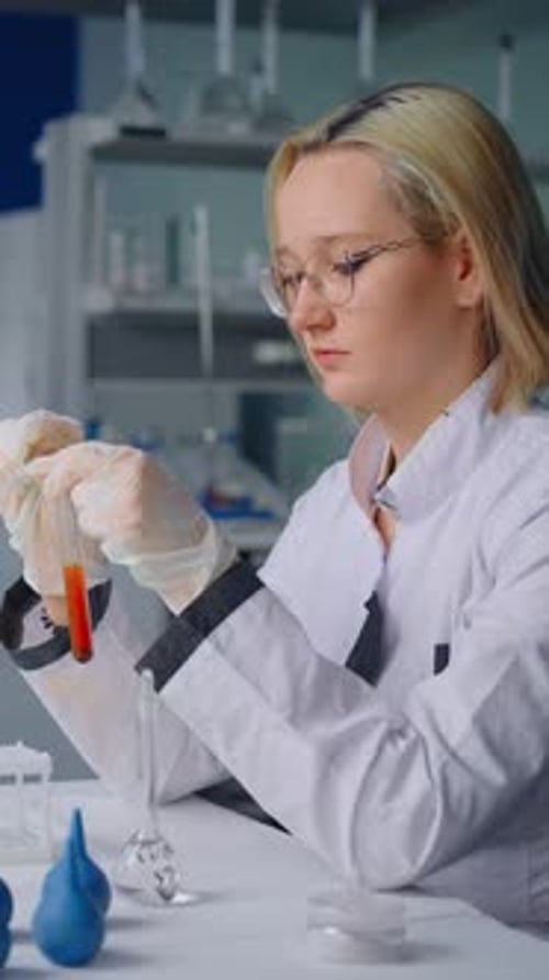 Young Woman Scientific Research in Lab with Test Tube