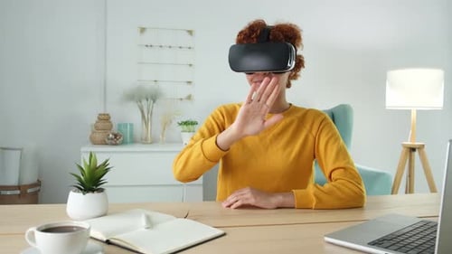 Woman Using VR Headset at Desk