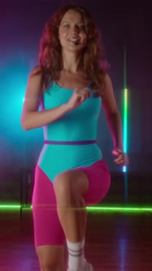 Woman in Leotard Doing Step Aerobics in Studio