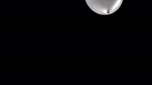 Glowing Balloon Falling on Black Background – Isolated on Green Screen, Luma key