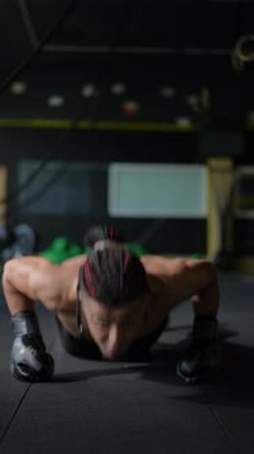 Engaging in an Intense Push Up Workout in a Gym Setting for Maximum Fitness and Results