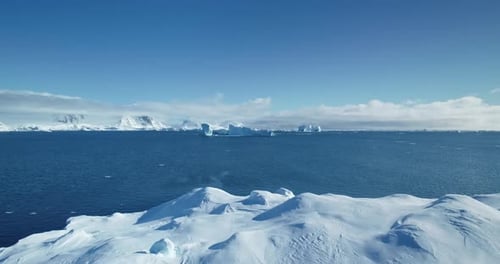 Fly Over Massive Snow Covered Iceberg Drift Ocean