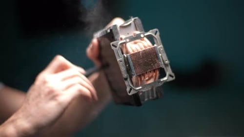 Repairman or Technician Working in Electronics Workshop or Hardware Computer Service Removing Dust