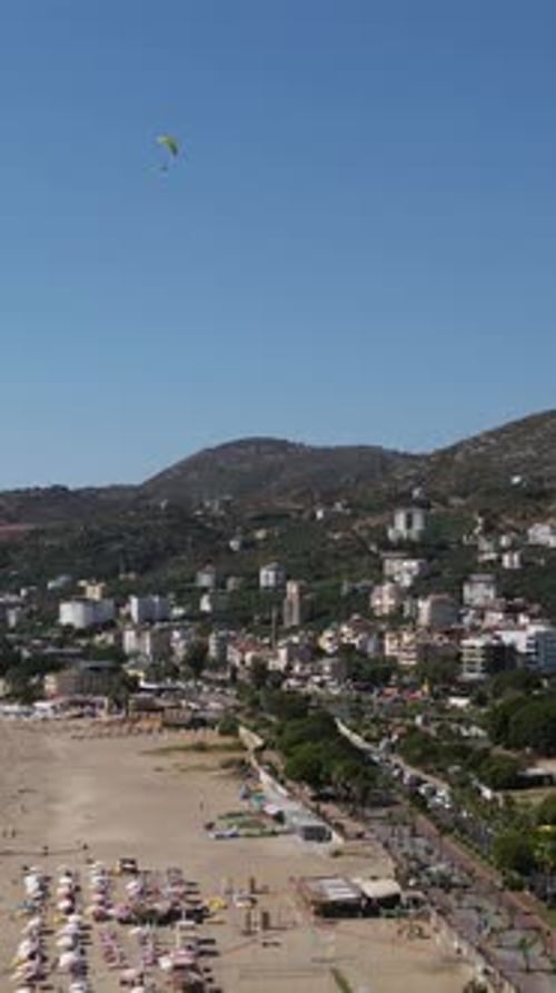 Beach Resort with Paragliders in Clear Blue Sky