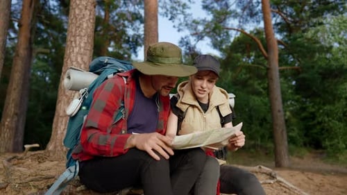 Couple Planning Route in a Forest