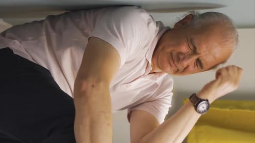 Man Rubbing Face In Distress Indoors