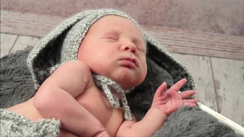 Sweet Infant Sleeping Peacefully in Grey Bunny Hat