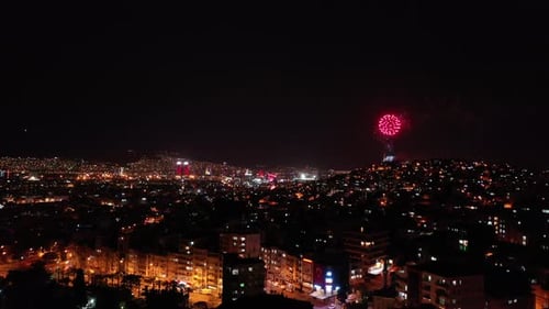 Celebratory fireworks exploding over the city at night for the new year celebration, izmir-turkey