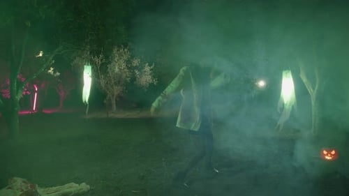Zombie Woman Walks And Dance Among Ghosts In Night Dark Forest During Halloween