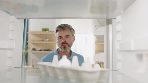Man Getting Egg from Refrigerator at Home