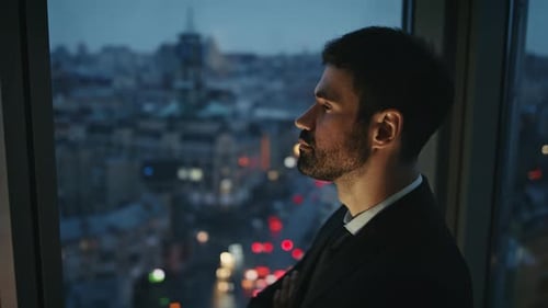Thoughtful Businessman Looking Evening Cityscape at Office Window Alone Close Up