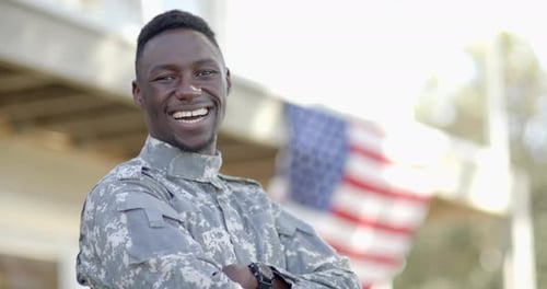 Soldier Smiling in Front of American Flag