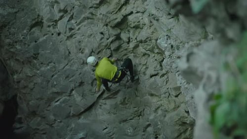 Active Alpinist Bearded Guy Wearing Helmet Gripping Holds Climbing the Mountain Rock Nature