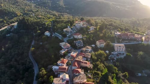 Aerial drone shot of Avliotes, a traditional hilltop village in Corfu, Greece, showing the church, c