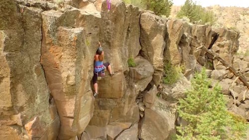 Aerial View of Woman Rock Climbing Mountain 2 Above
