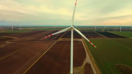 Large Wind Turbines in Field Aerial View Rotating Blades Generate Clean Electric Power at Cloudy Day