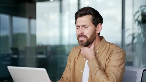 Man with Sore Throat at Office Desk
