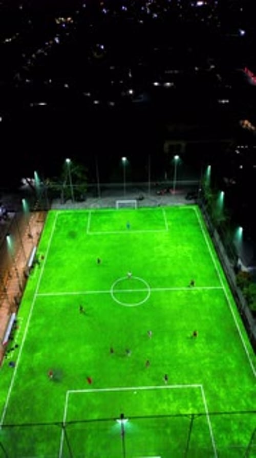 Vertical Drone Footage of mini football match, soccer. MiniFootball field and Footballers from drone