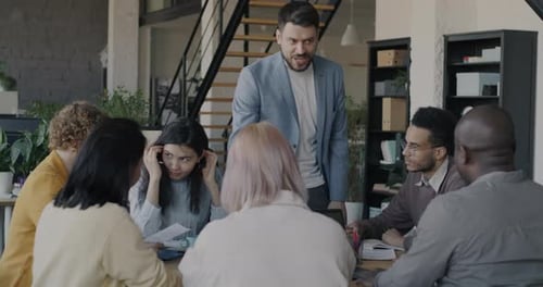 Furious CEO Screaming at Group of Office Workers Blaming People of Crisis and Mistakes