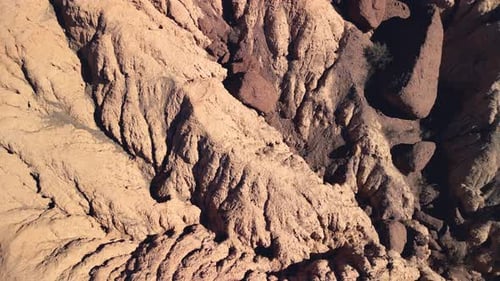 Aerial top view drone flying over scenic red rocky mountains.