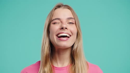 Smiling Woman with Blonde Hair Winking at Camera