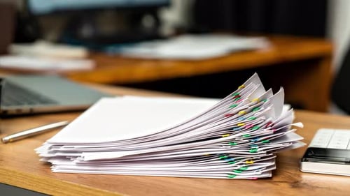 Bundle of Documents Sheets with Important Information Taken From Large Pile on Table Fastened with