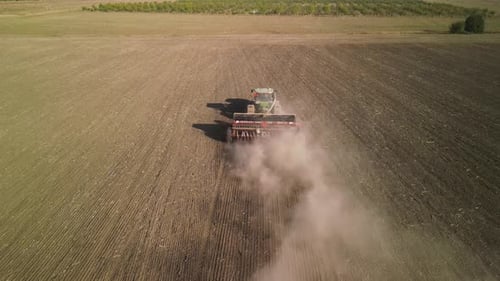 Tractor on the field seeding wheat