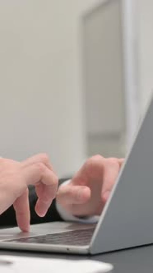 Close up of Businessman Typing on Laptop, vertical video