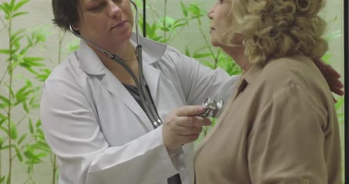 Doctor Uses Stethoscope to Check Senior Woman's Heart