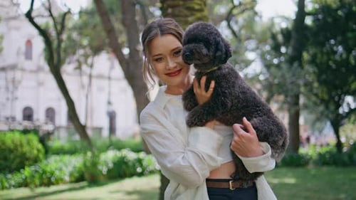 Cheerful Girl Posing Poodle in Sunny Park Closeup Smiling Woman Cuddling Pet