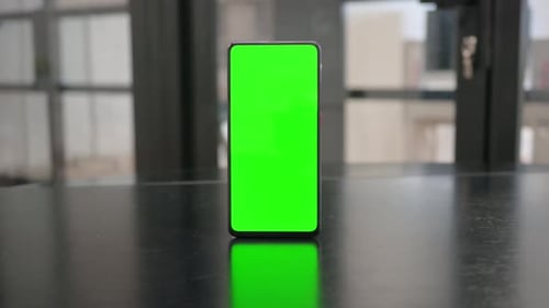 Phone with Green Screen on Desk