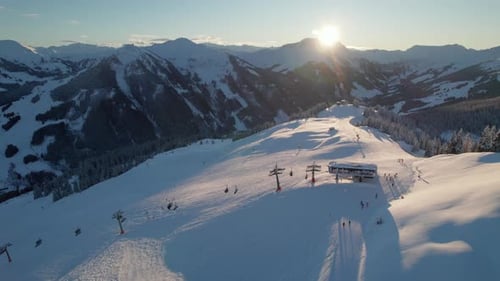 Cable Cars And Skiers On Snowy Mountain Zwolferkogel In Saalbach-Hinterglemm, Austria. Sunny Morning